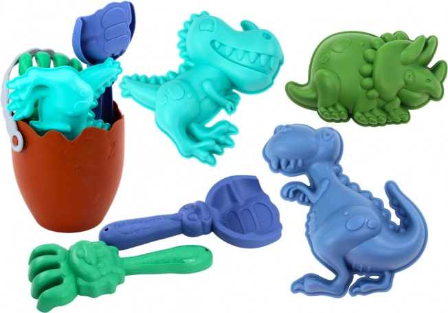 Písková sada dinosauři s vědrem ve tvaru vejce, lopatkou, hráběmi a formičkami