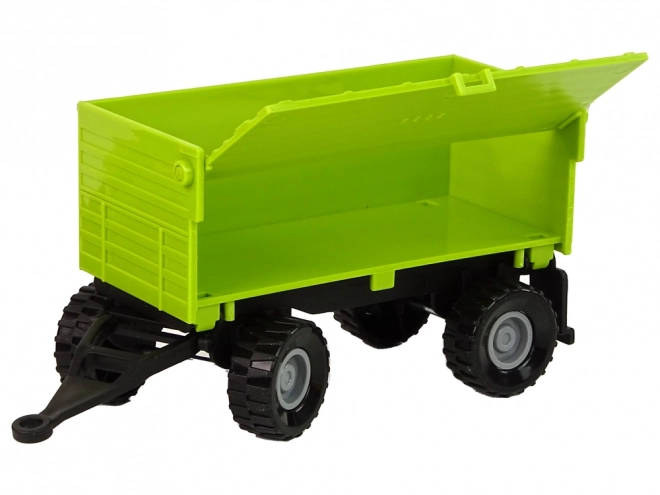 Zelený zemědělský traktor s přívěsem