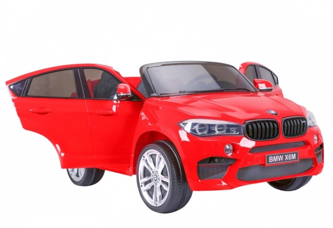 BMW X6M XXL pro 2 děti Červená + dálkové ovládání + eko kůže + bezpečnostní pásy + pomalý rozjezd + MP3 USB + LED dioda