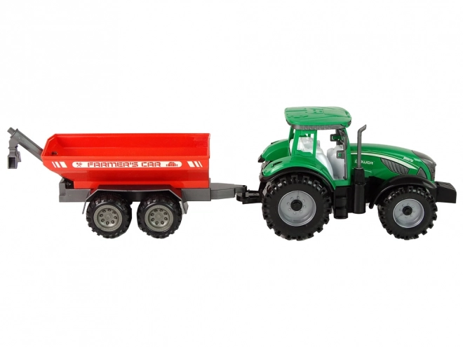 Zelený traktor s červeným třecím pohonem přívěsu
