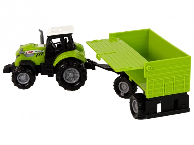 Zelený zemědělský traktor s přívěsem