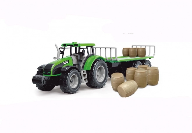 Traktor se setrvačníkem a přívěsem plným sena