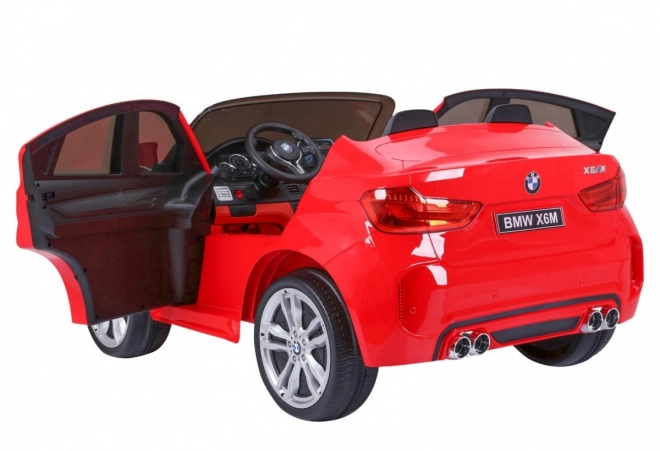 BMW X6M XXL pro 2 děti Červená + dálkové ovládání + eko kůže + bezpečnostní pásy + pomalý rozjezd + MP3 USB + LED dioda