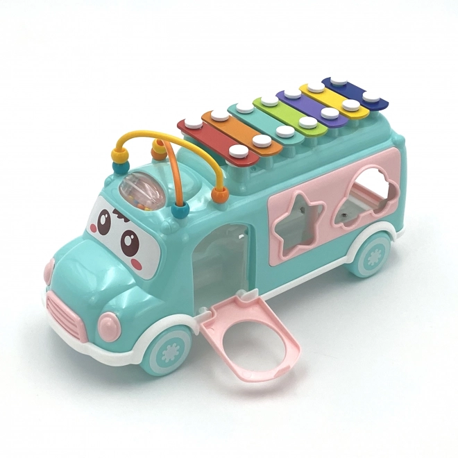 Woopie muzicírovací auto se zeleným sorterem a xylofonem