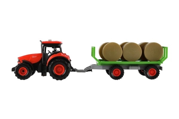 Traktor se zvukem a světlem s odpojitelným vlekem a balíky sena