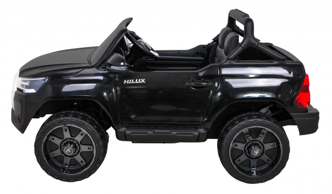 Toyota Hilux baterie pro děti černá + pohon 4x4 + dálkové ovládání + 2 nosiče zavazadel + rádio MP3 + LED dioda