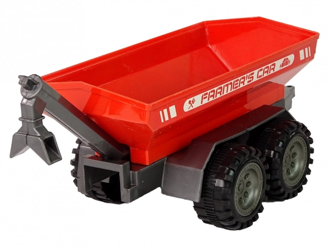 Zelený traktor s červeným třecím pohonem přívěsu