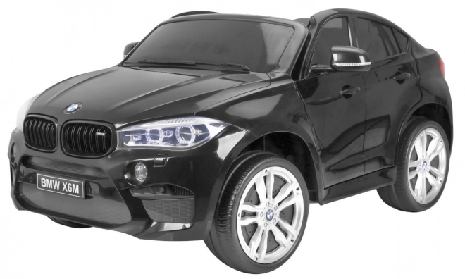 BMW X6M XXL pro 2 děti Lak černá + Dálkové ovládání + Eko kůže + Bezpečnostní pásy + Pomalý rozjezd + MP3 + LED