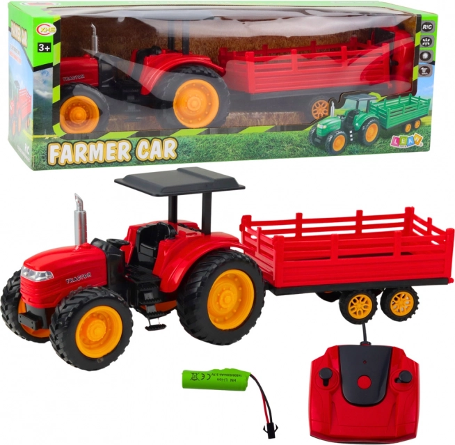 Zdalně ovládaný farmářský traktor s přívěsem červený