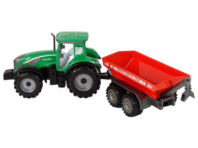 Zelený traktor s červeným třecím pohonem přívěsu