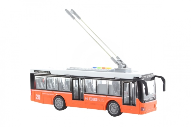 Oranžový hrající a svítící trolejbus na baterie