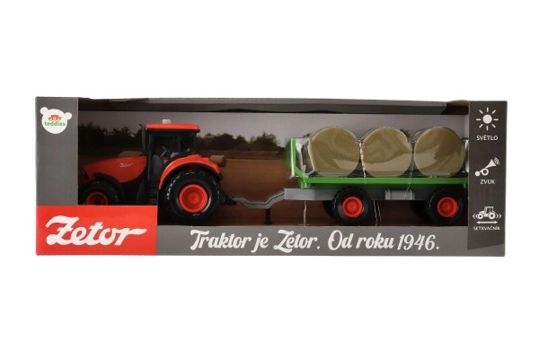 Traktor se zvukem a světlem s odpojitelným vlekem a balíky sena