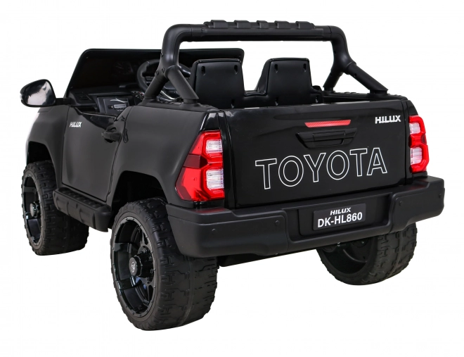 Toyota Hilux baterie pro děti černá + pohon 4x4 + dálkové ovládání + 2 nosiče zavazadel + rádio MP3 + LED dioda