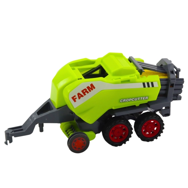 Zelený traktor s lisem na balíky sena