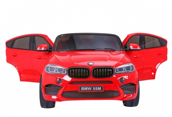 BMW X6M XXL pro 2 děti Červená + dálkové ovládání + eko kůže + bezpečnostní pásy + pomalý rozjezd + MP3 USB + LED dioda