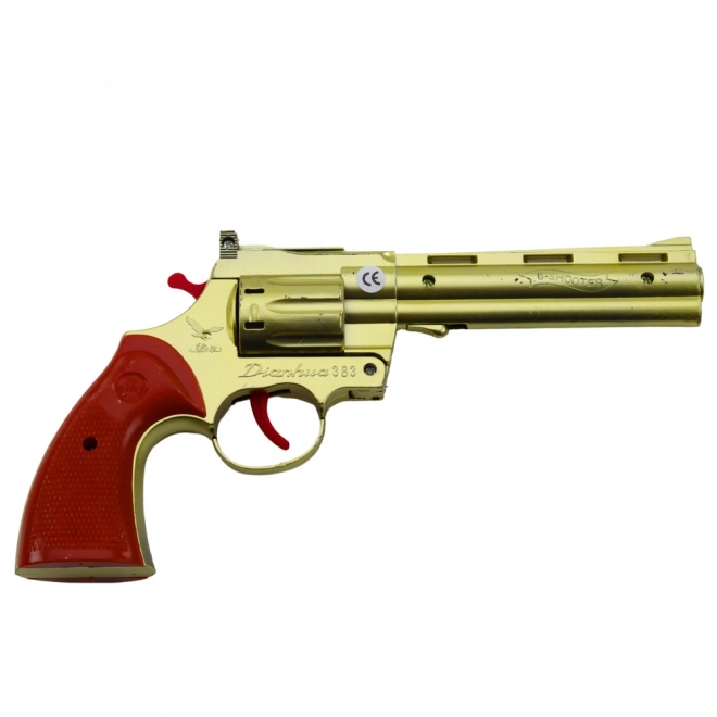 Zlatý revolver na kapsle s efektem zvuku výstřelu