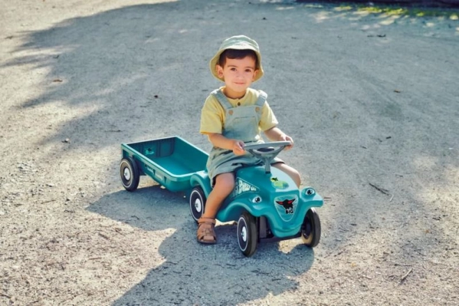Auto odstrkovadlo s vozíkem v tyrkysové barvě