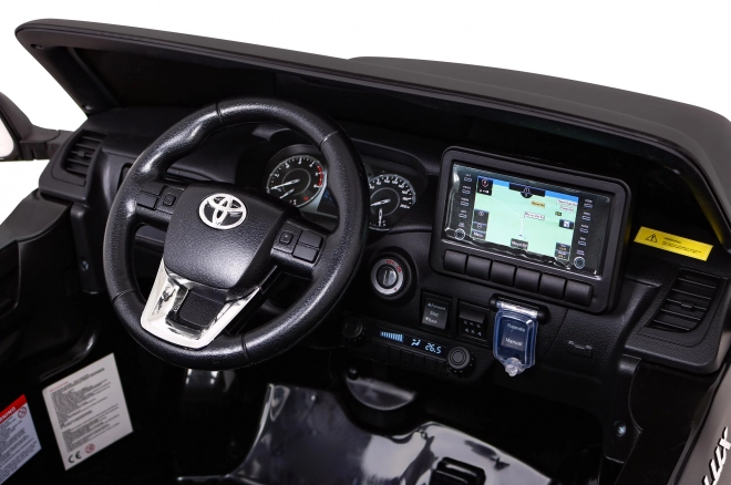 Toyota Hilux baterie pro děti černá + pohon 4x4 + dálkové ovládání + 2 nosiče zavazadel + rádio MP3 + LED dioda